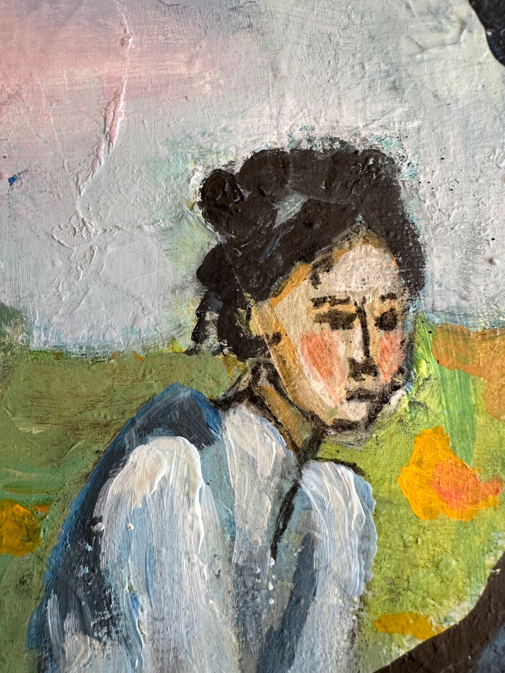 Close-up of a textured painting with a focus on a face.